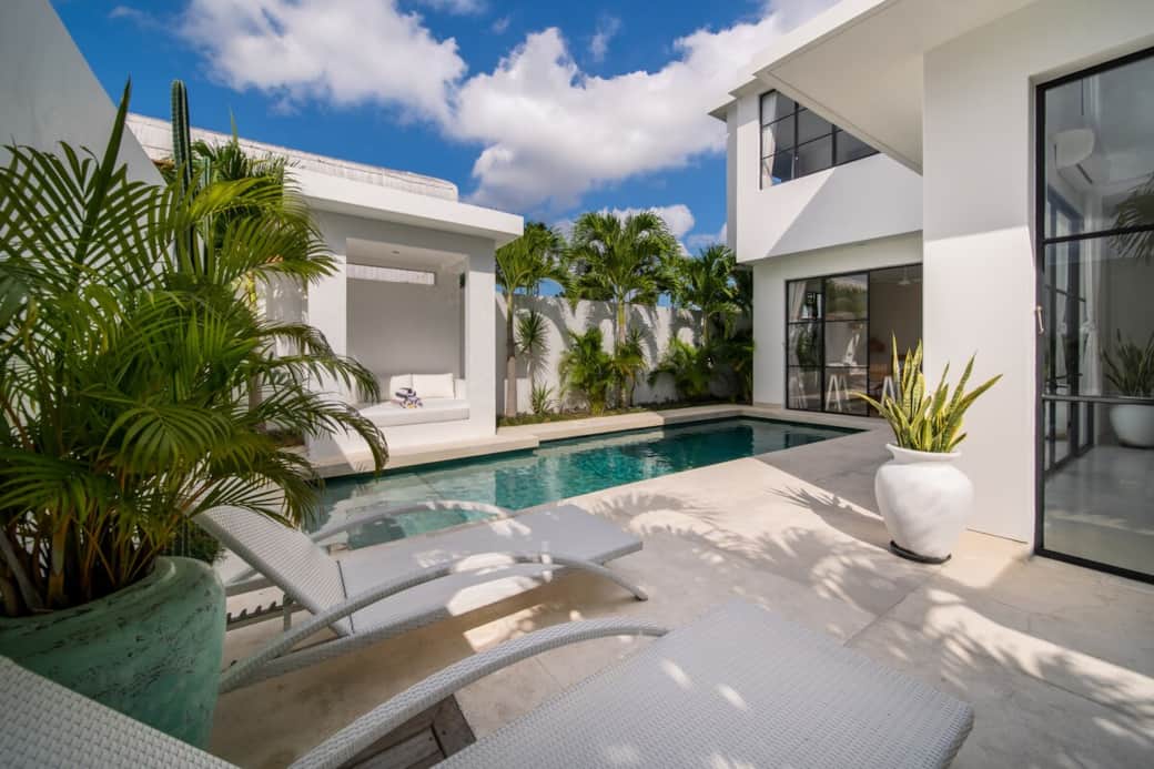Enjoy your morning coffee by the pool on these comfortable sun loungers.