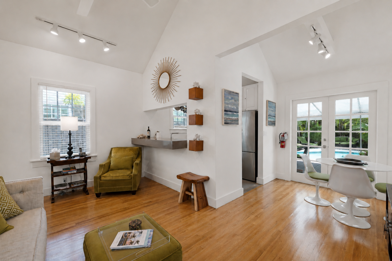 Living and dining area with French doors leading to the private heated pool.