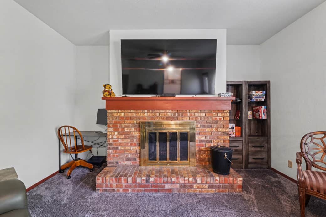 Family Room with a large Roku TV, a work area with a monitor and power, plenty of seating and games.