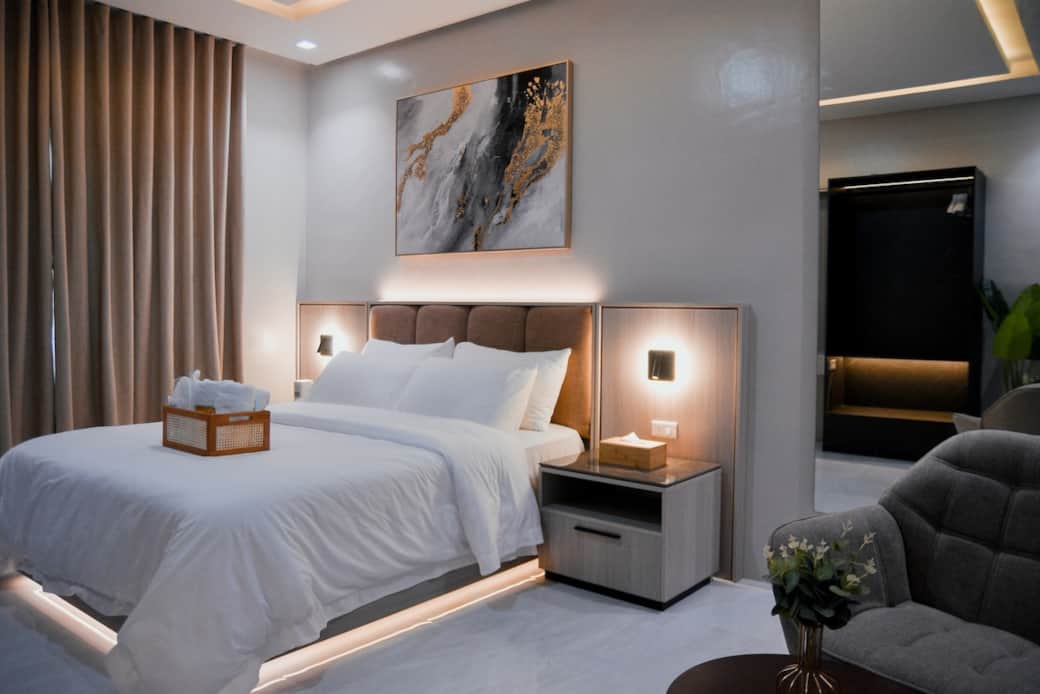 Relax in a stylish hotel-like studio with warm lighting and a 5-star queen bed.