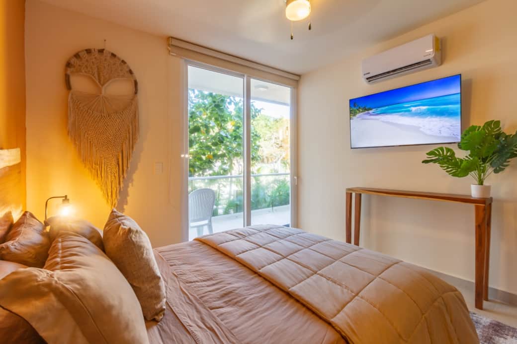Master bedroom sanctuary: queen bed, 55" smart TV, private balcony. Your ultimate retreat awaits!
