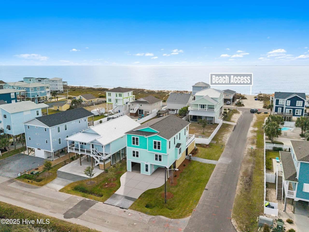 Only a 90-second walk to the beach, The Cottage is to the left of the green house.