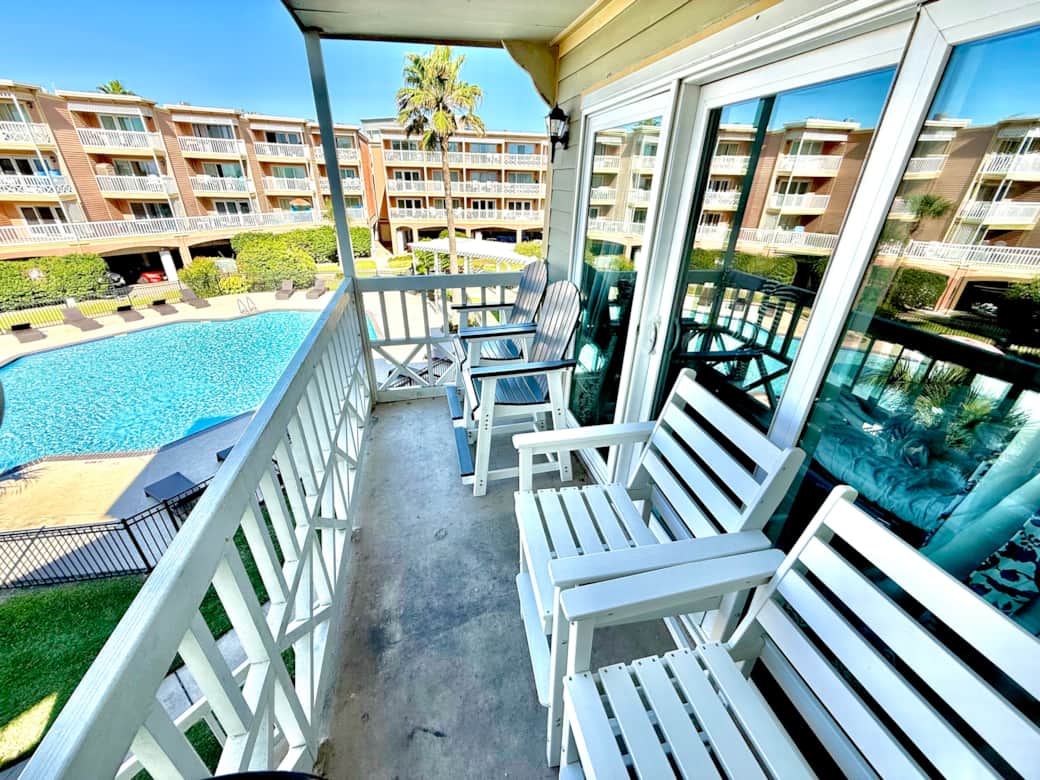 4 tall Adirondack chairs with view of Gulf and Pool