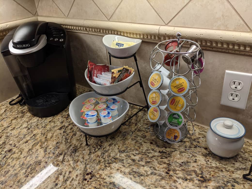 Complete coffee bar with K-cups, tea, creamer, sweetener, and sugar available at no charge.
