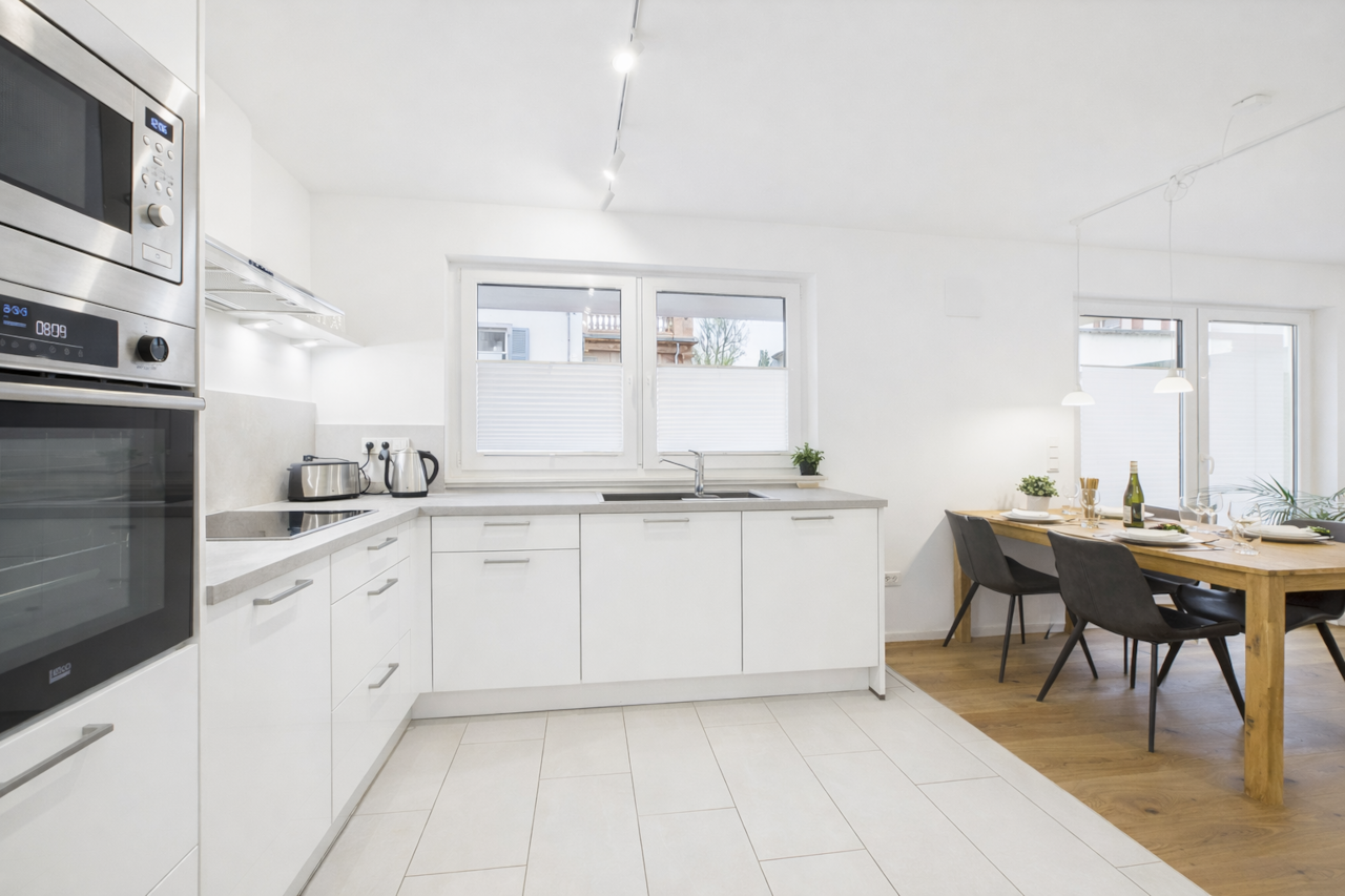 Fully equipped, modern kitchen with oven, microwave, dishwasher, and plenty of space.