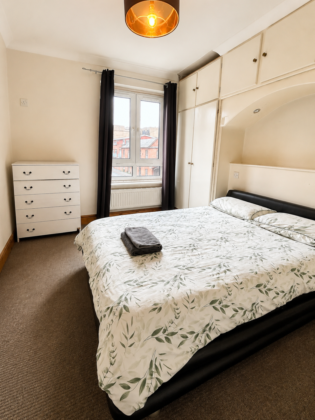 Main bedroom with natural light and city views