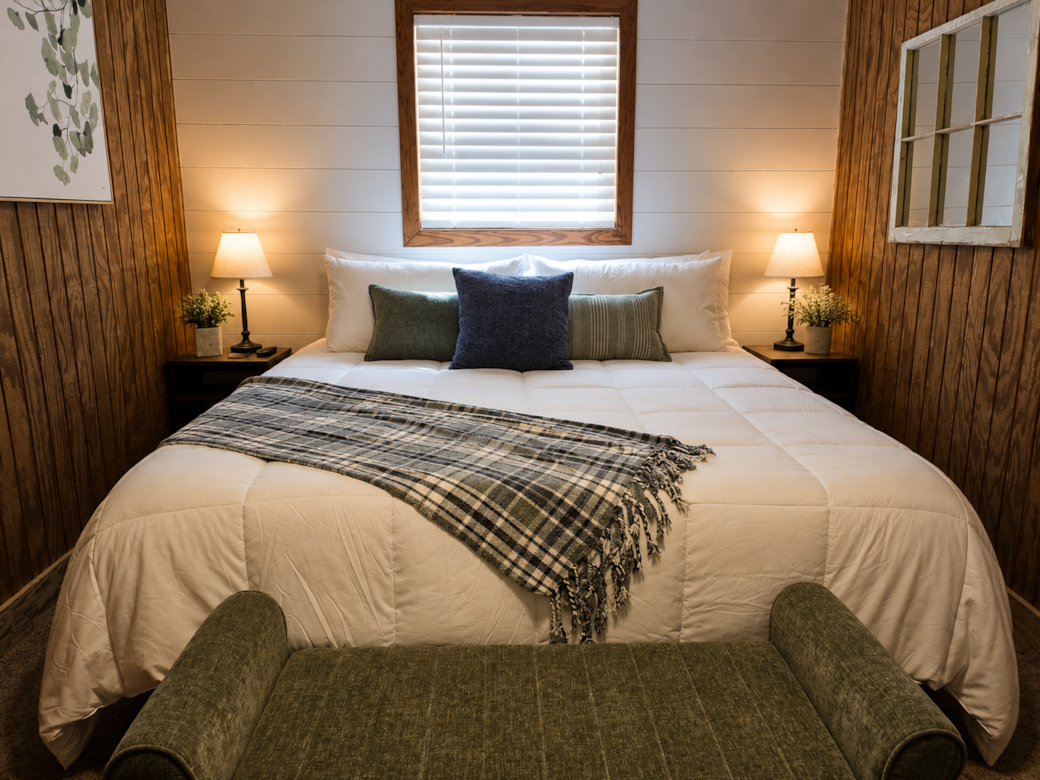 Cozy king bedroom with plush bedding and warm modern farmhouse charm