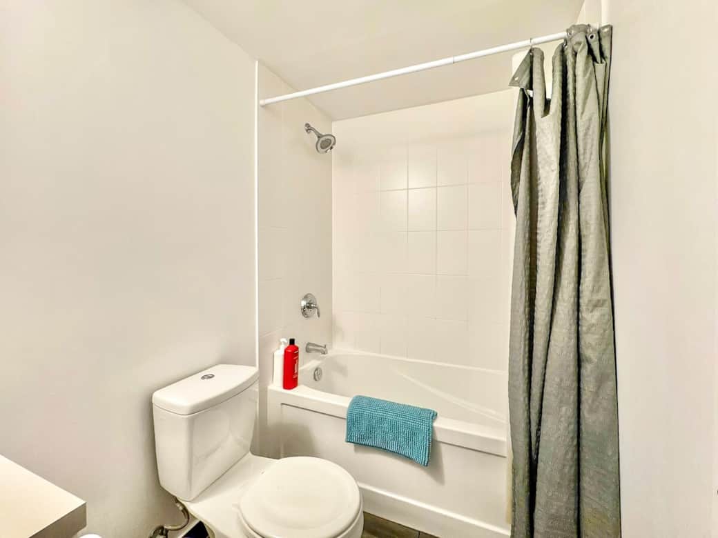 Refresh and unwind in a modern full-size bathroom featuring a sleek shower, clean fixtures, and essential toiletries. Thoughtfully designed for comfort and convenience, it’s the perfect spot to start your day or relax after a long one.
