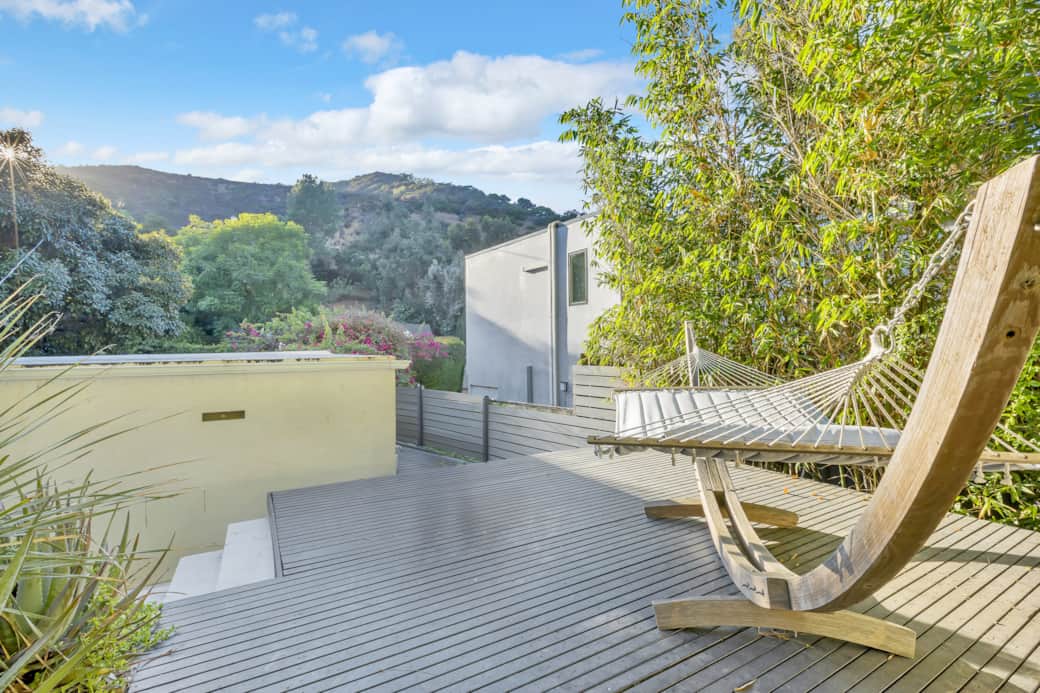 Sun-drenched deck with hammock seating offers a serene spot to enjoy the scenery in style. Sun-drenched deck with hammock seating offers a serene spot to enjoy the scenery in style.
