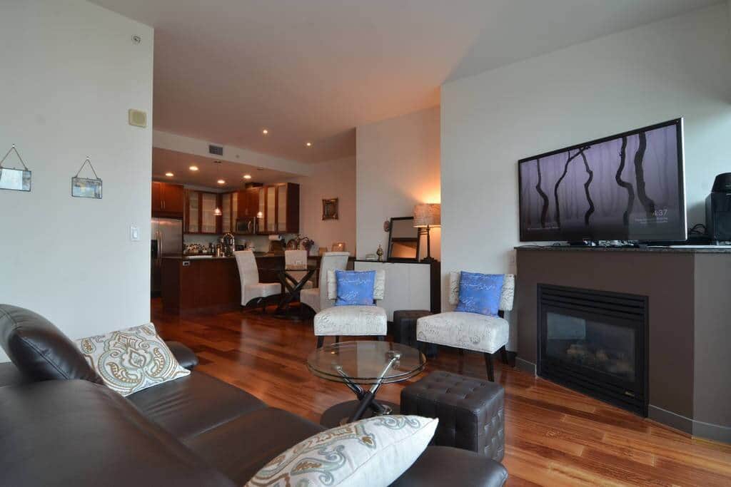 Spacious living room with flatscreen TV and beautiful city views