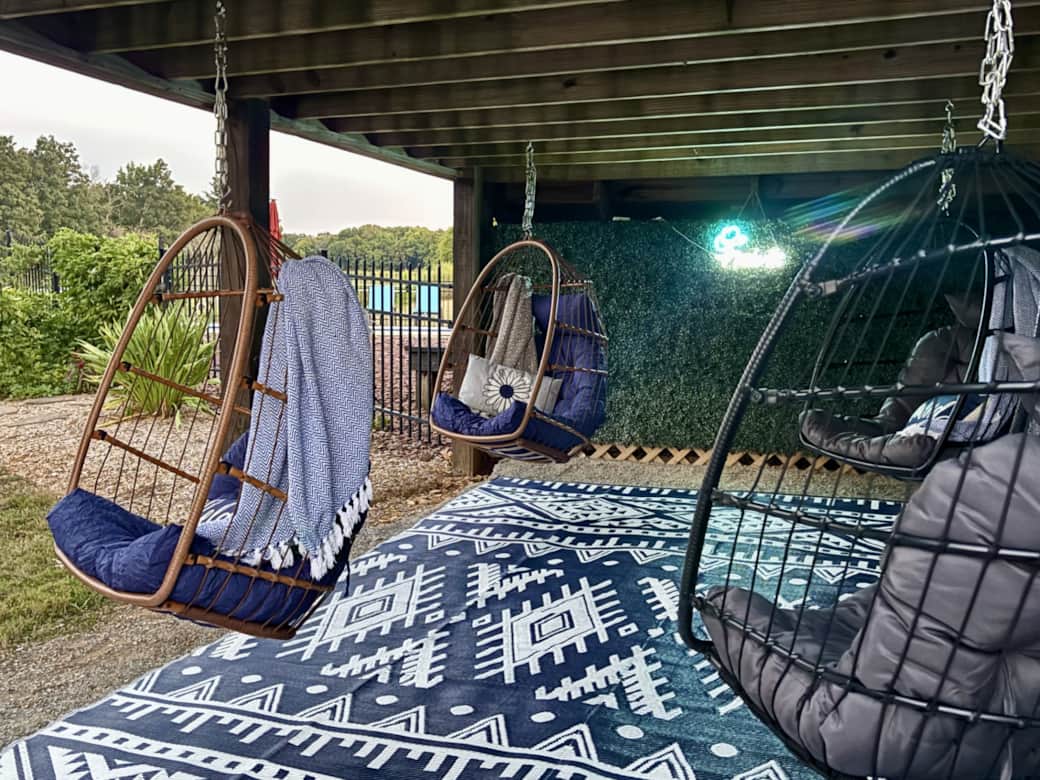 Under the deck there are 4 swinging egg chairs overlooking the back of the property.