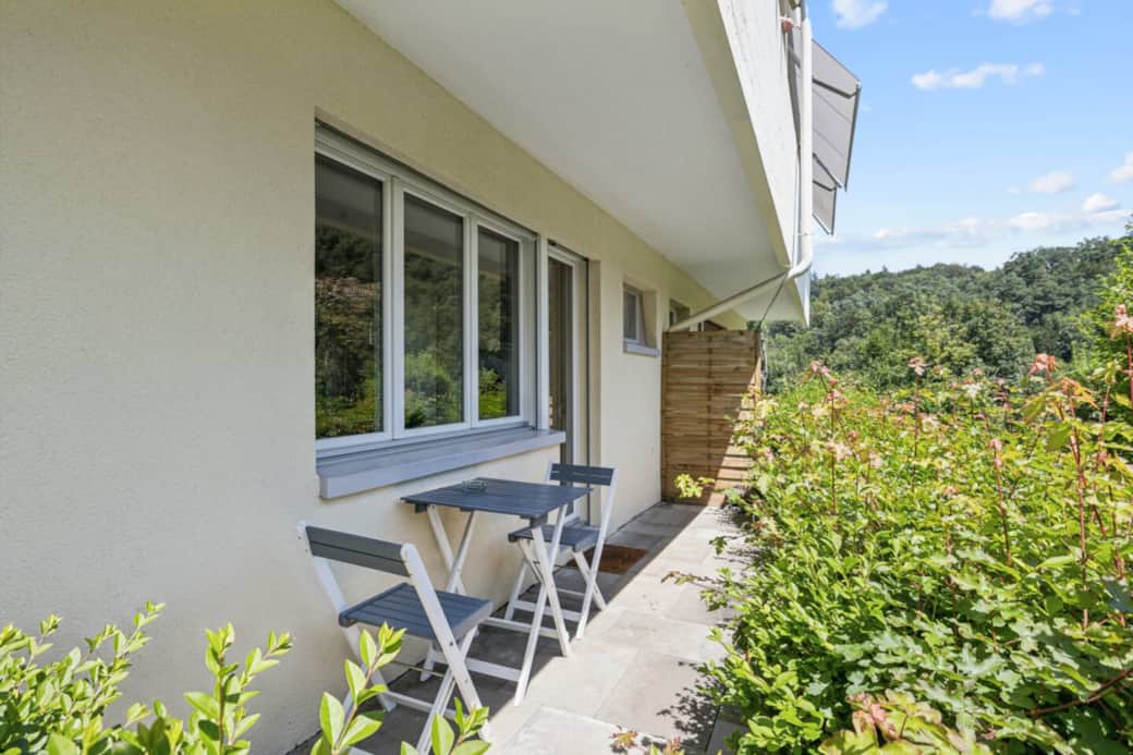 Cozy bistro corner on the terrace with relaxing green hillside views. Cozy bistro corner on the terrace with relaxing green hillside views.
