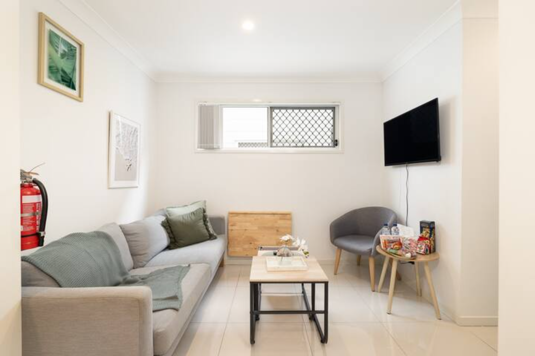 Living Area: Bright living space with comfortable seating and TV 