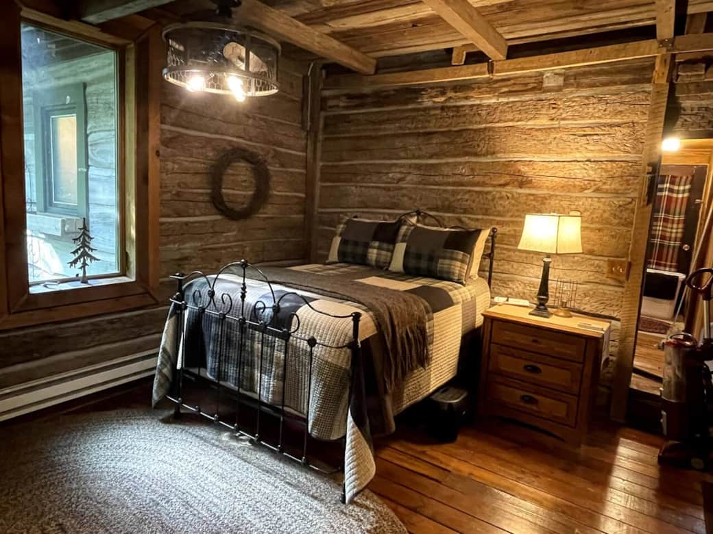 Full size antique bed in the old part of the cabin. 