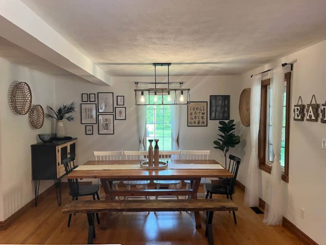 Dining table with bench seating in open concept kitchen.