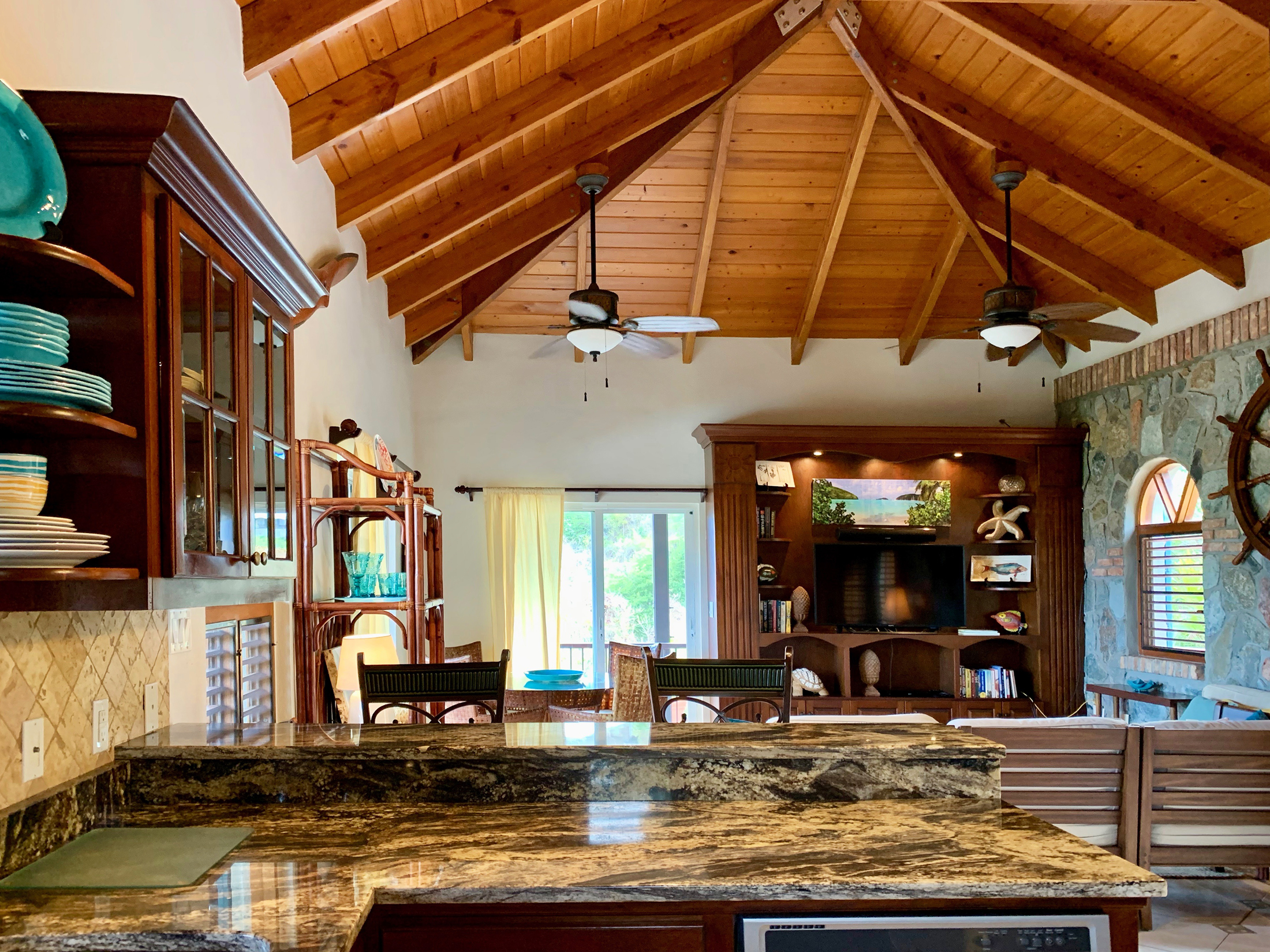Open kitchen space with bar seating into living area