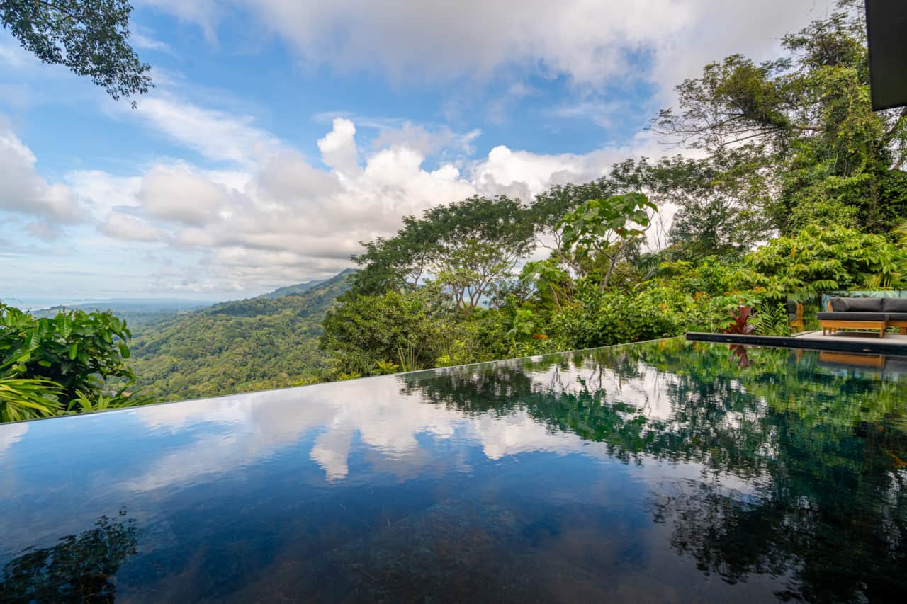 Infinity pool reflecting the Pacific and jungle