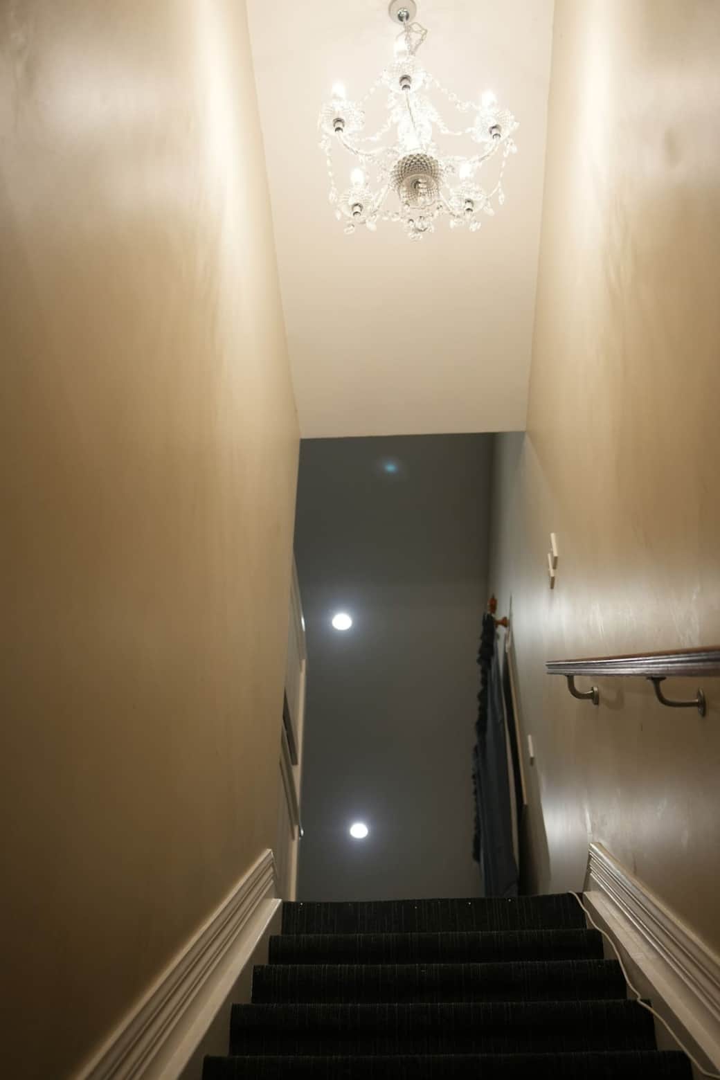 staircase with chandelier light