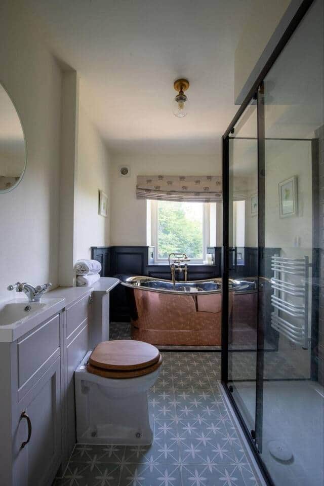 Stylish bathroom with freestanding copper bath and walk-in shower