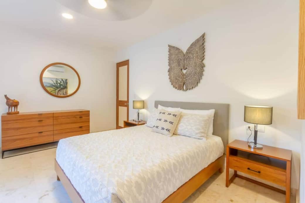 This bedroom includes dressers for your clothes, two nightstands with lamps, and easy-access plug-in outlets on both sides of the bed, perfect for charging phones and other electronics comfortably during your stay.
