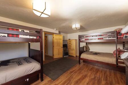 Bunk room with multiple beds for family accommodations