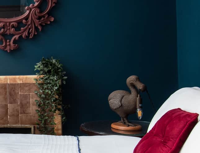 Rich blue room for a Dodo-inspired Caucus Race! Luxurious bed and mascot guarantee a fun, restful st