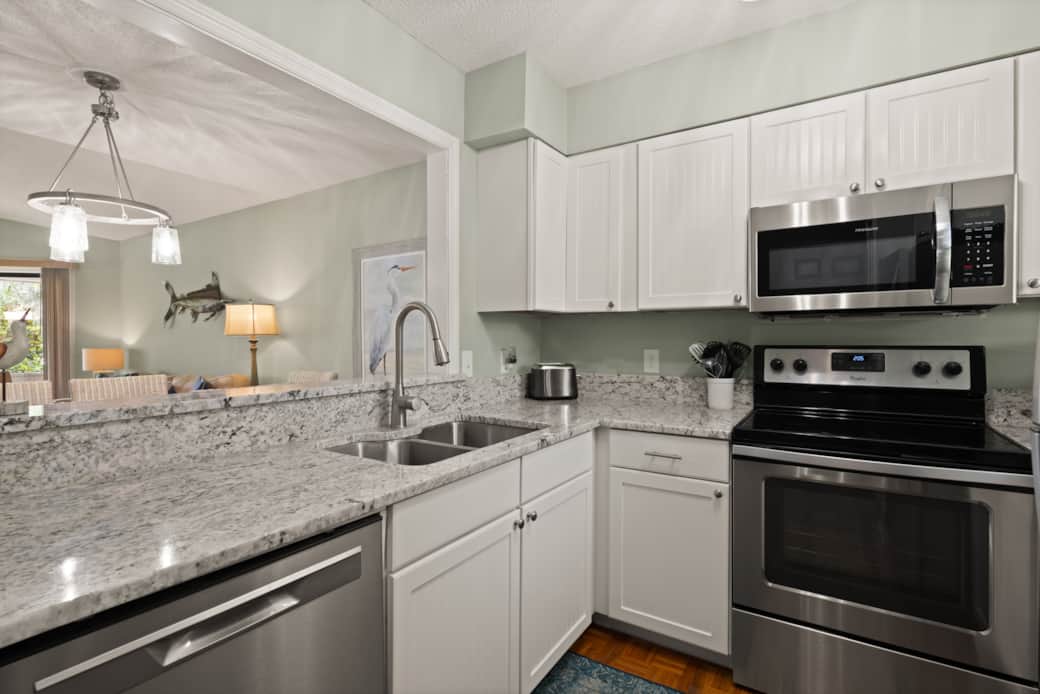 The kitchen has a large opening that allows you to see the dining area and Great Room. 