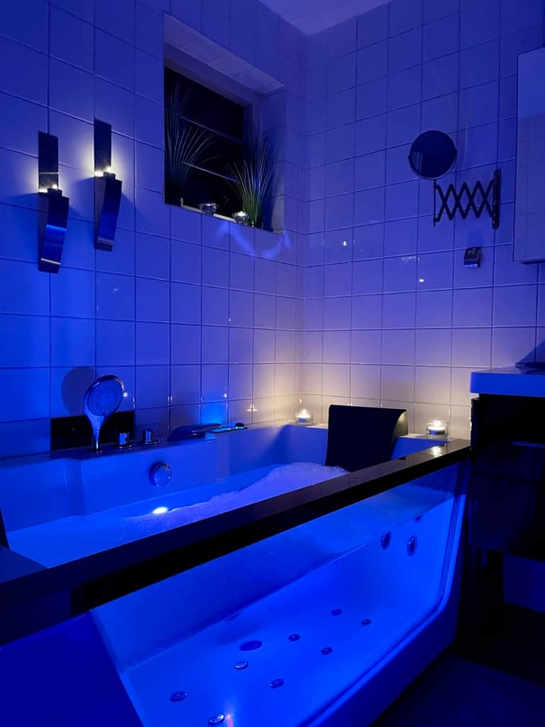 Glass bathtub for two with light therapy on the ground floor
