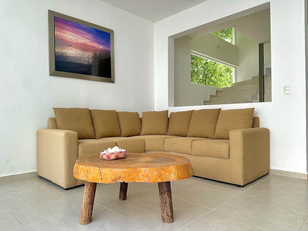 Open living space: living room, kitchen, dining area, patio