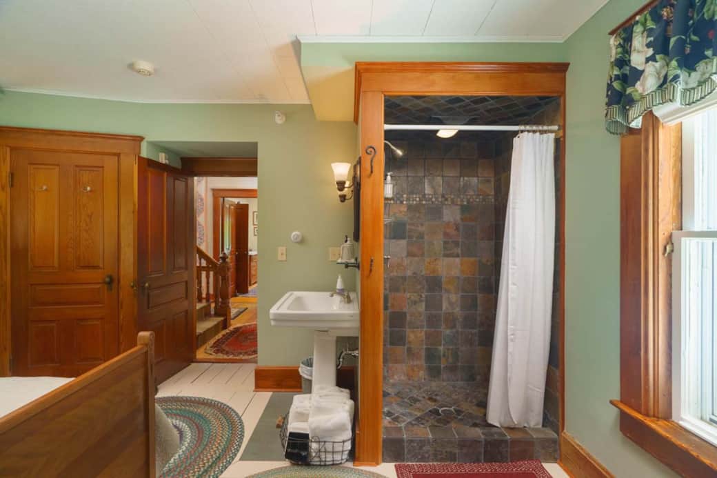 In-room shower with slate tile accents offers a unique feature. In-room shower with slate tile accents offers a unique feature.