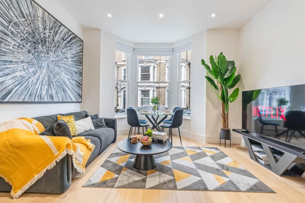 Bright, modern living space with bay windows, stylish décor and a cosy spot to unwind with Netflix after exploring London.