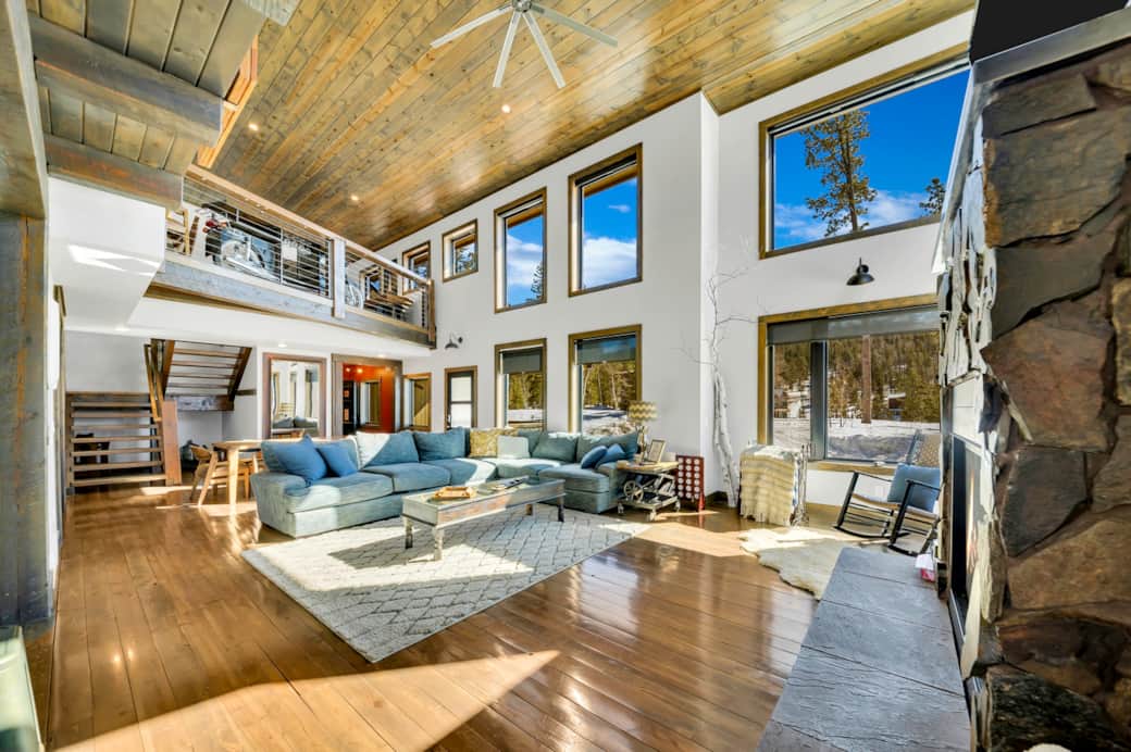 View of living and dining rooms with expansive windows to take in the pines and views View of living and dining rooms with expansive windows to take in the pines and views