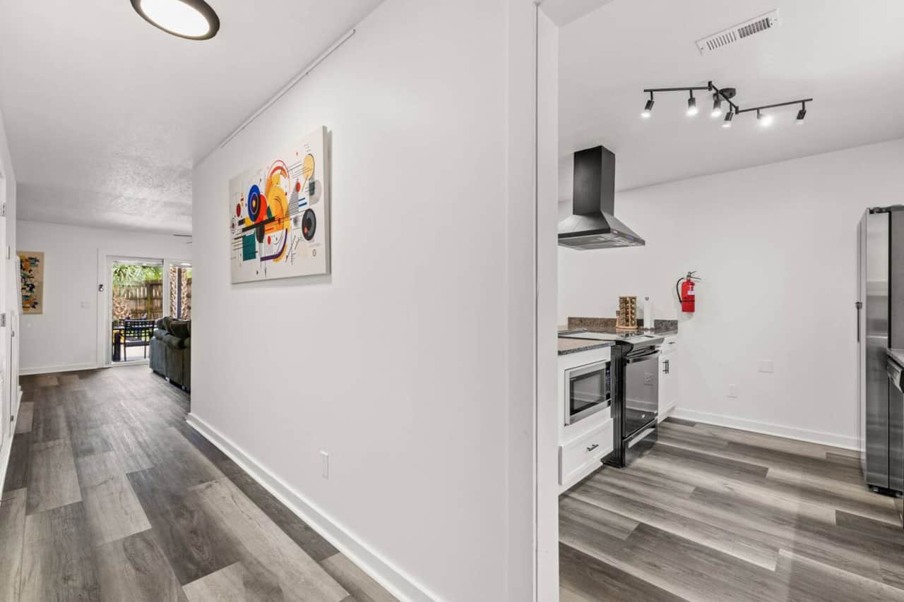 Enjoy 1,360 square feet across two floors. Downstairs: a stocked kitchen, dining area, lounge with a smart TV, laundry, and half bath. All three bedrooms and both full bathrooms are upstairs, separating sleeping spaces from the main gathering area