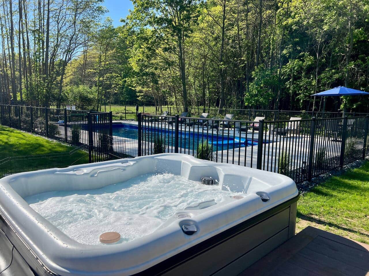 Hot tub overlooking the pool back yard