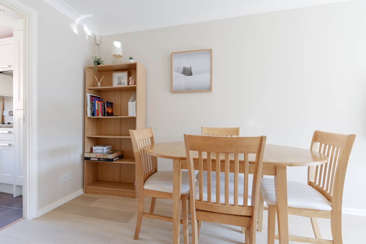 Dining nook with bookshelf and vintage style game collection