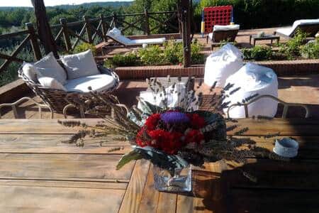 Poolside lounge area with panoramic countryside views