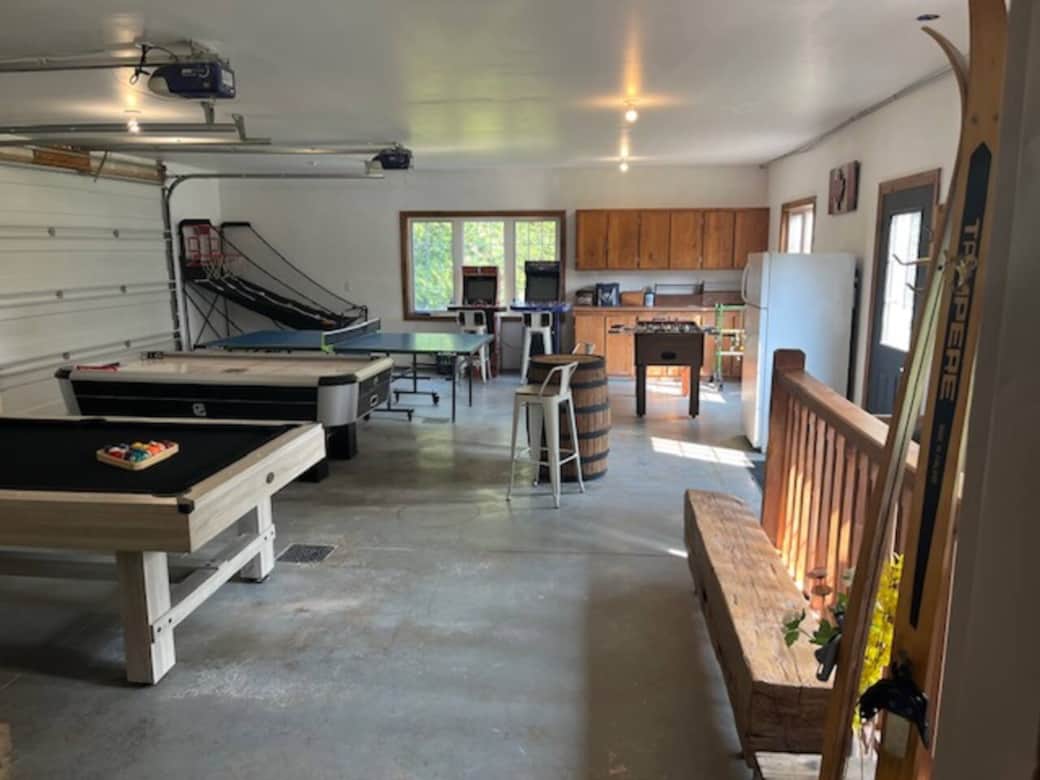 Games room with pool table, air hockey, ping pong, foosball, and basketball shootout as well as NBA Jam and NFL Blitz arcade games for hours of enjoyment.