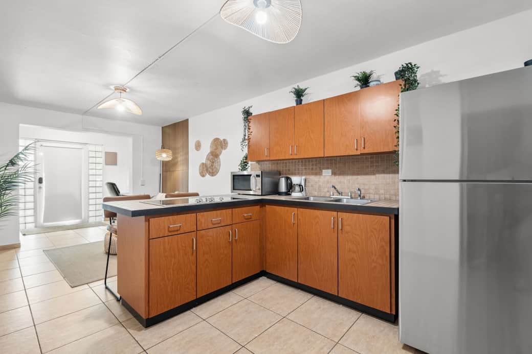Bright kitchen with full-size appliances and warm wood cabinetry
