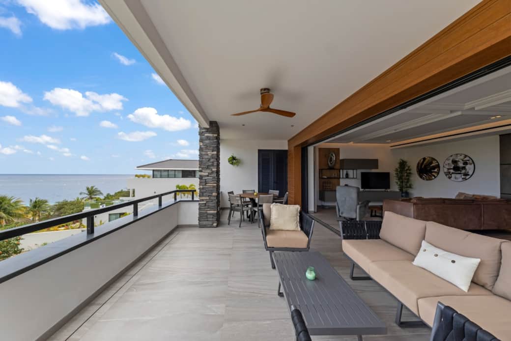 Spacious balcony with dining table and seating area