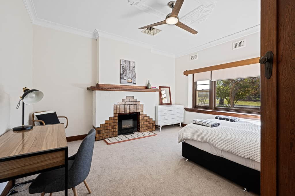 Queen sized bed and large, art deco bay windows make this a unique space to relax.