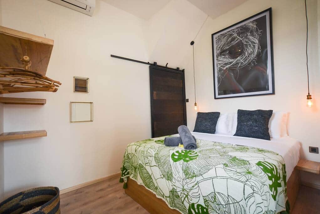 Tropical-style bedroom with comfortable bedding