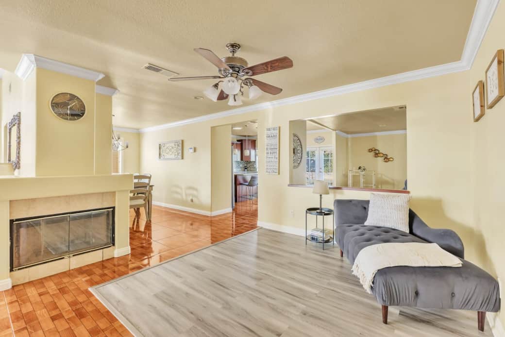 Living area with fireplace, lounge seating, and open flow to dining space.