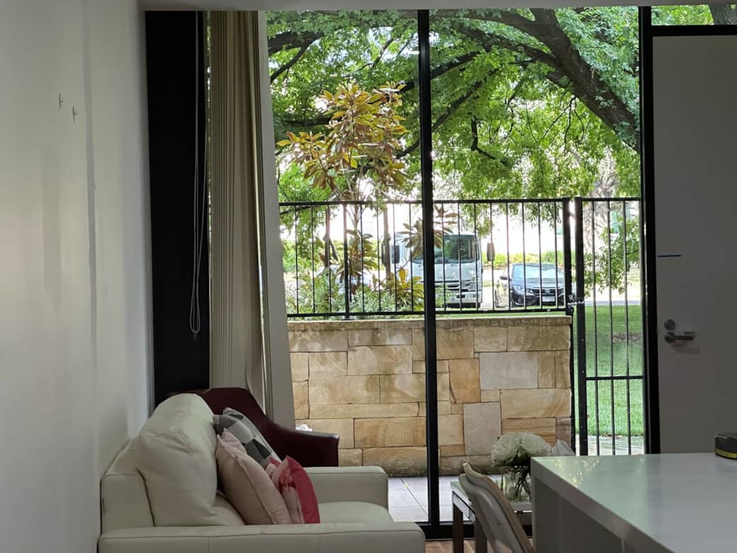 Relax in the comfort of our living room, where a plush sofa and a flat-screen TV await. The large window offers a picturesque view of the park, bringing a touch of nature into your living space.