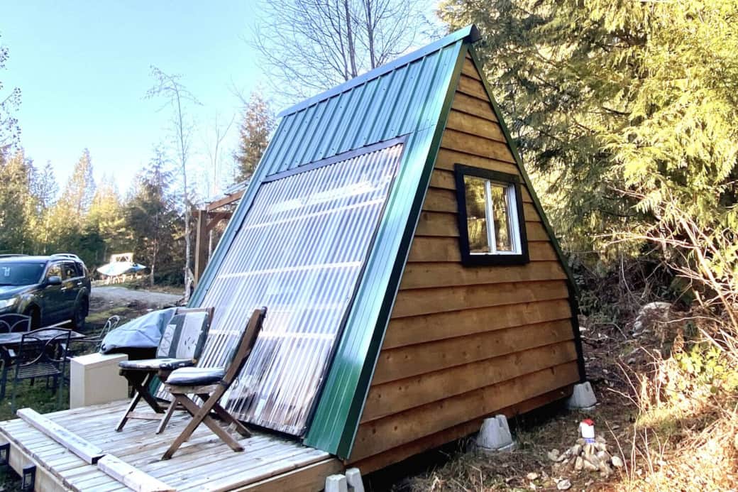 Side view of A-frame showing deck with chairs and parking. Nice and private. Side view of A-frame showing deck with chairs and parking. Nice and private.
