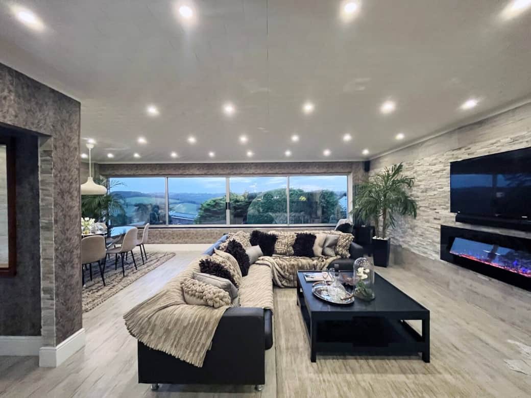 Living /Dining Room with Bar Area, wine cooler and amazing views over the rolling hills of Surrey. Enjoy evenings in by the fire watching a movie or  two,  or having a lovely meal.