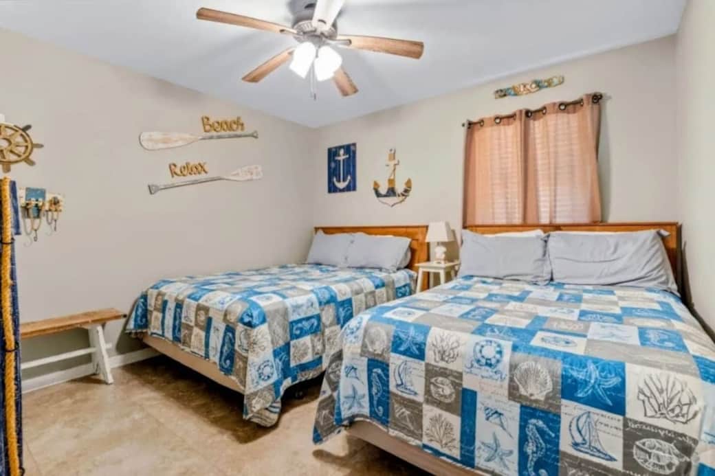 One queen and one full bed in gust bedroom