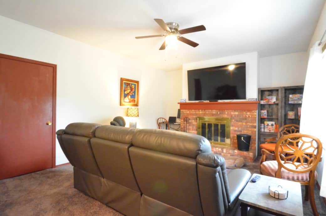 Family Room with a large Roku TV, a work area with a monitor and power, plenty  seating and games.