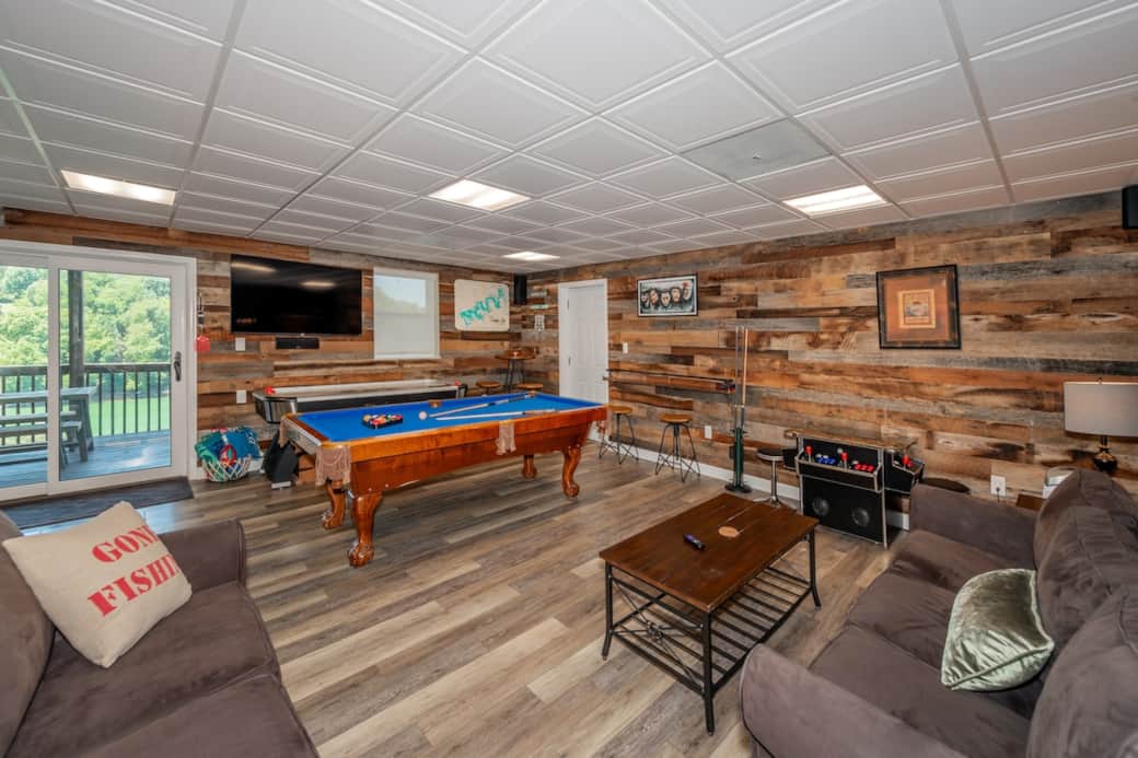 GAME TIME! Walk-out basement game room awaits family fun playing pool, air hockey, arcade games and watching the game on the Roku TV. You’ll access the lower deck from this room.