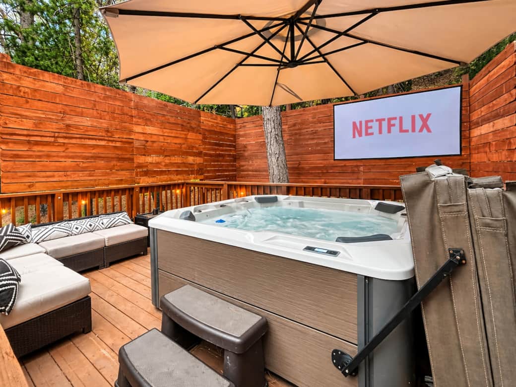 Soak in the hot tub under the stars while your favorite movie plays on the 100" outdoor projector. Soak in the hot tub under the stars while your favorite movie plays on the 100" outdoor projector.