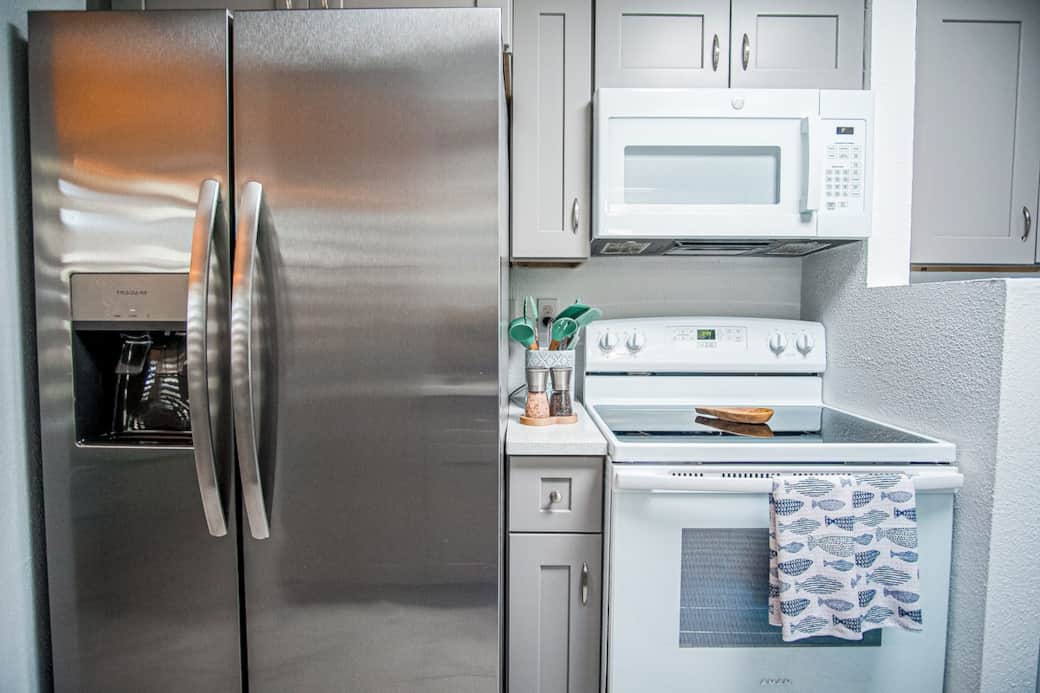 Fully equipped kitchen featuring a stainless steel refrigerator with filtered water dispenser and ice maker, plus microwave, oven, and freezer. Fully equipped kitchen featuring a stainless steel refrigerator with filtered water dispenser and ice maker, plus microwave, oven, and freezer.